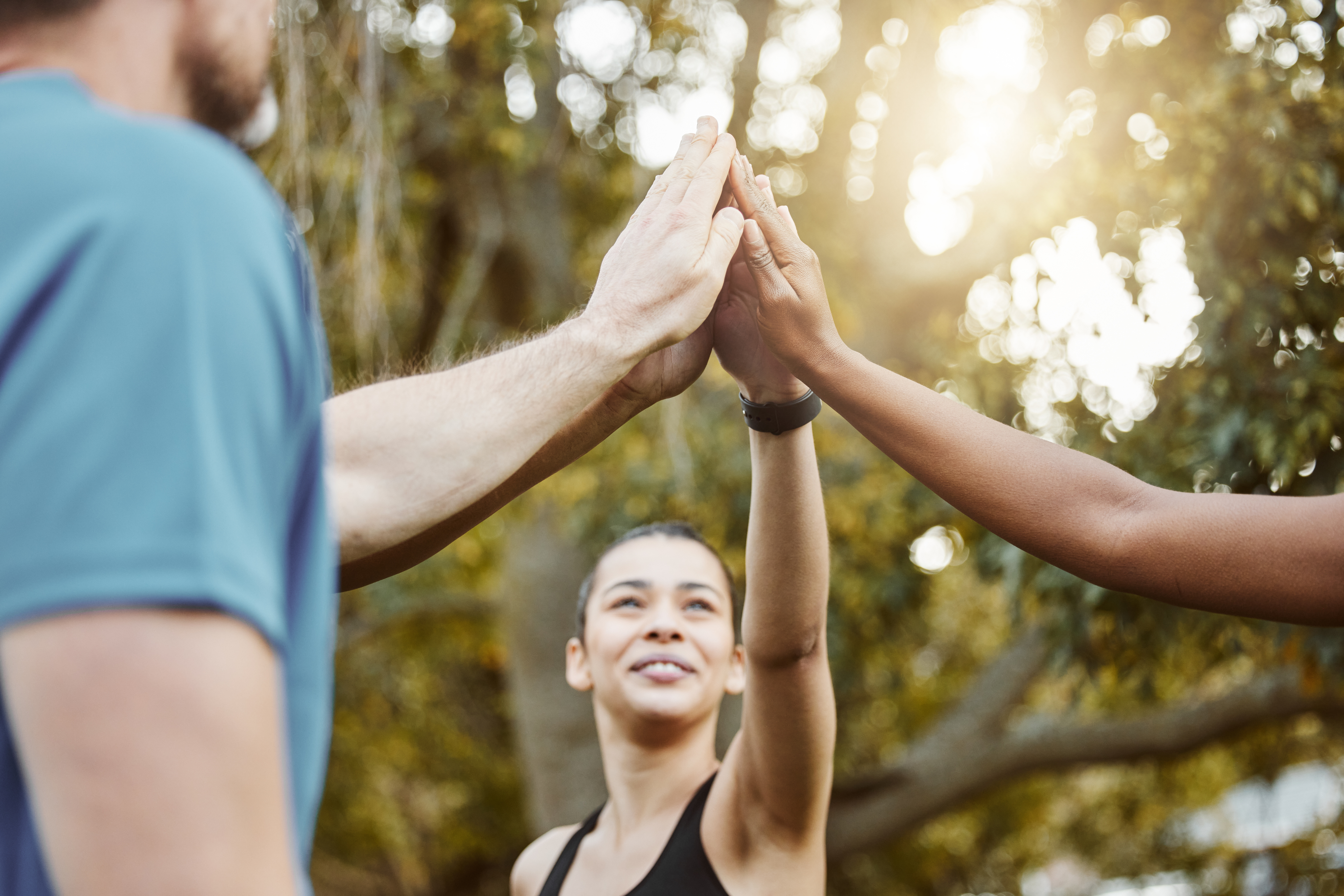 Hands, high five with exercise group and success in team of people outdoor, help and support with t.